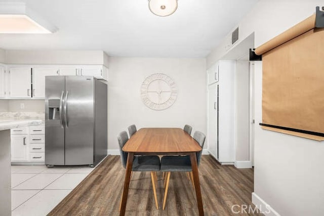 dining area with visible vents, baseboards, and light tile patterned floors