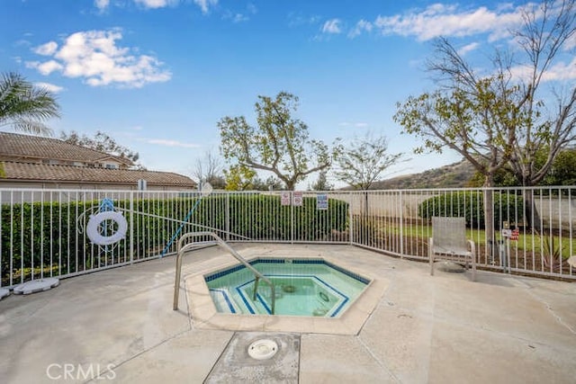 view of swimming pool featuring a community hot tub and a patio area