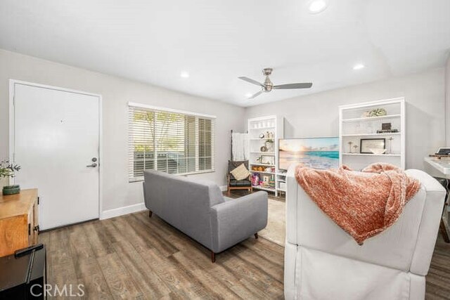 living room with hardwood / wood-style floors and ceiling fan