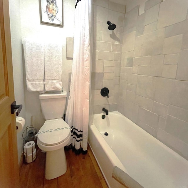 bathroom featuring hardwood / wood-style flooring, toilet, and shower / bath combo