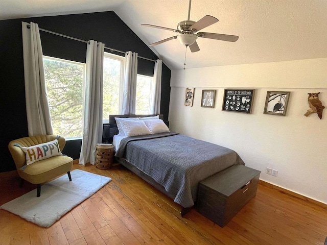 bedroom featuring ceiling fan, wood-type flooring, and vaulted ceiling