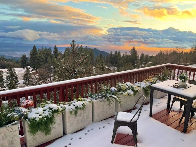 view of snow covered back of property