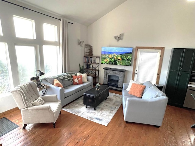 living room featuring light wood-type flooring and high vaulted ceiling