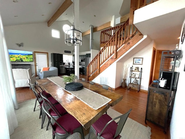 dining space featuring a notable chandelier, wood-type flooring, high vaulted ceiling, and beamed ceiling