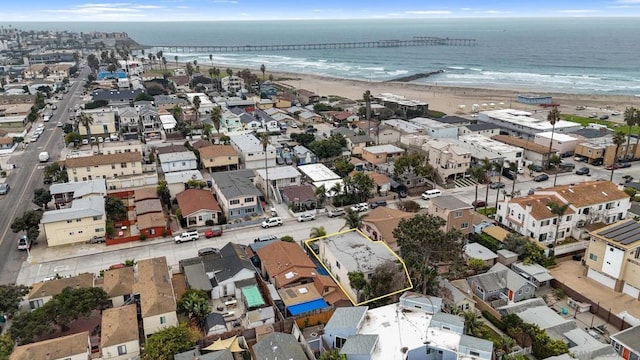 birds eye view of property with a water view and a view of the beach