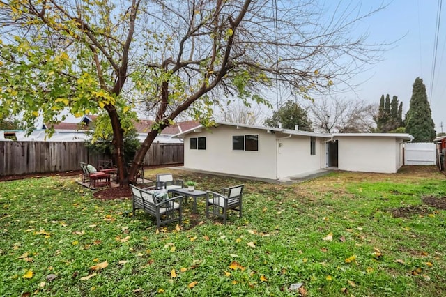 rear view of house featuring a yard