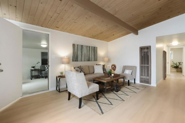 living room with vaulted ceiling with beams, light hardwood / wood-style floors, and wooden ceiling