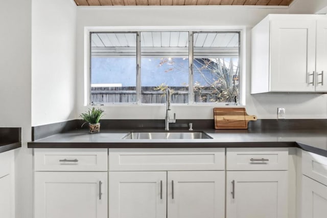 kitchen featuring white cabinetry and sink