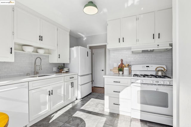 kitchen with white cabinets, white appliances, and decorative backsplash