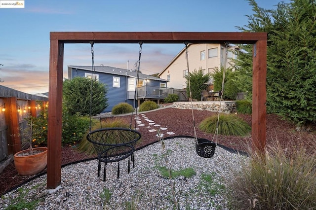 yard at dusk featuring a patio