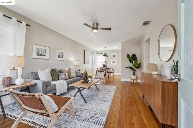 living room with hardwood / wood-style floors and ceiling fan