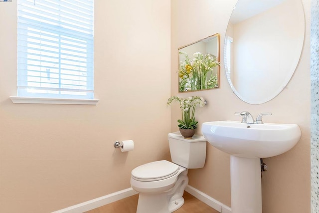 bathroom with toilet and hardwood / wood-style floors