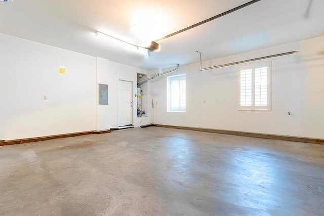 garage featuring electric panel and water heater