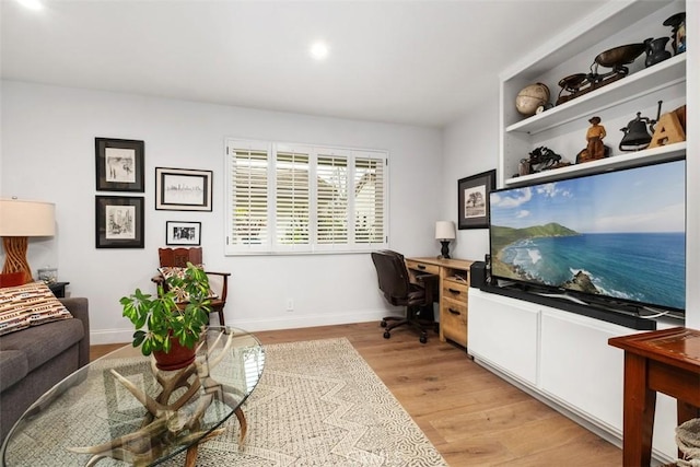 office area with light hardwood / wood-style floors