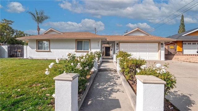 ranch-style home with a garage and a front lawn