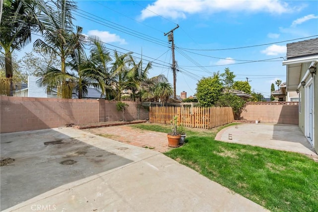 view of yard featuring a patio area and a fenced backyard