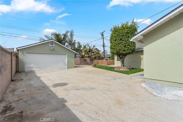 detached garage featuring fence