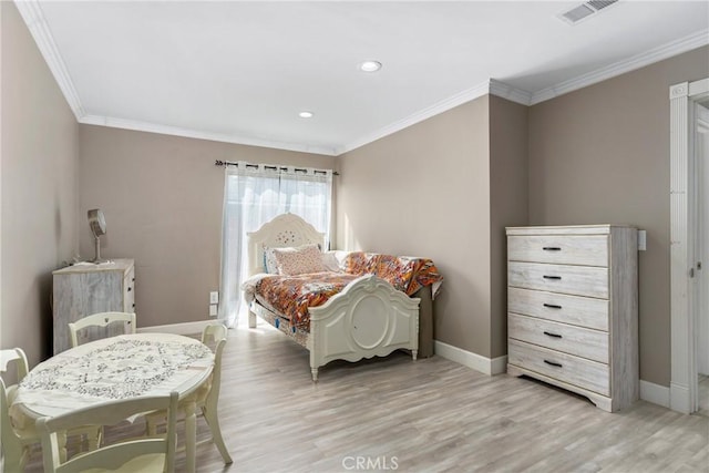 bedroom featuring visible vents, light wood-type flooring, baseboards, and ornamental molding