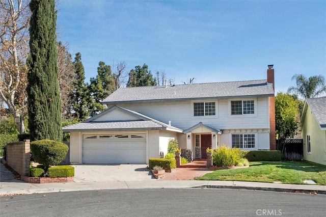 view of front of home with a front lawn and a garage