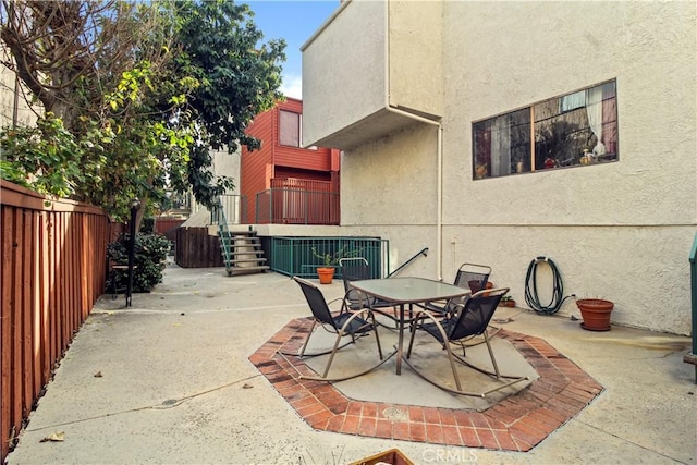 view of patio / terrace featuring outdoor dining area and fence