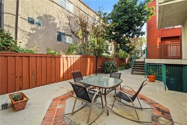 view of patio featuring outdoor dining space and a fenced backyard