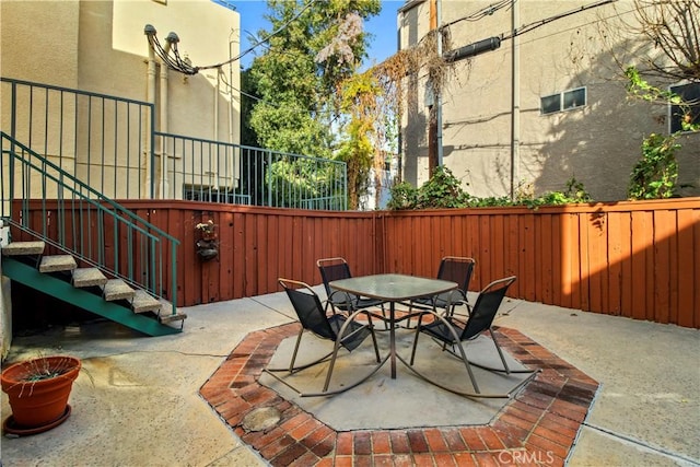 view of patio with fence and outdoor dining area