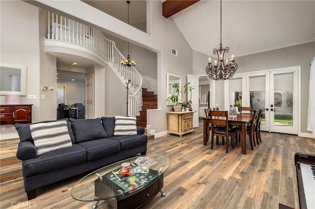 living room featuring high vaulted ceiling, hardwood / wood-style flooring, a notable chandelier, beam ceiling, and french doors