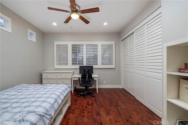 bedroom with dark hardwood / wood-style floors, ceiling fan, and a closet