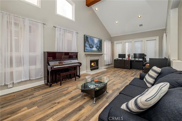 living room featuring hardwood / wood-style flooring, high vaulted ceiling, and beamed ceiling