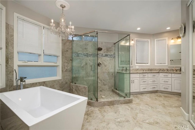 bathroom with vanity and shower with separate bathtub