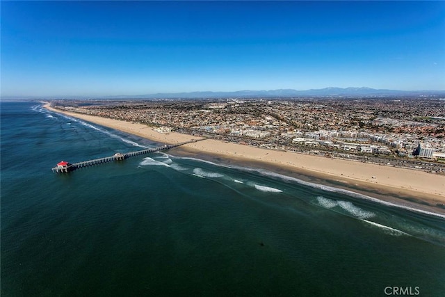 bird's eye view with a water view and a beach view