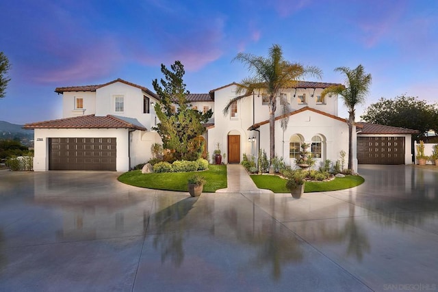 mediterranean / spanish-style home featuring a garage