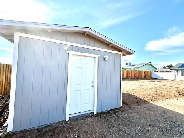 view of outbuilding featuring an outbuilding and fence
