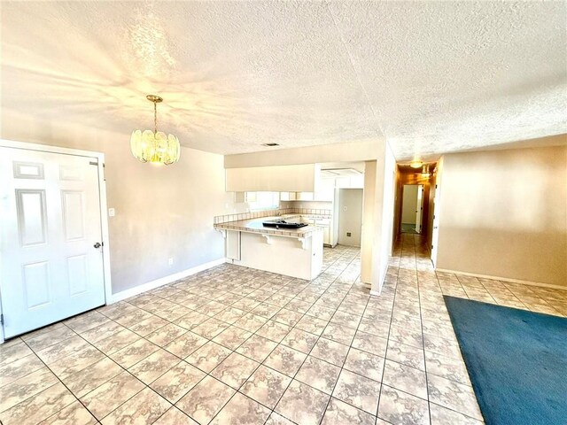 kitchen featuring a breakfast bar, decorative backsplash, white cabinets, decorative light fixtures, and kitchen peninsula