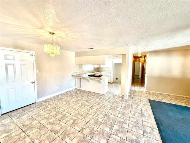 kitchen with open floor plan, white cabinetry, a peninsula, a breakfast bar area, and light countertops