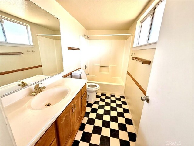 full bathroom featuring plenty of natural light, toilet,  shower combination, and vanity