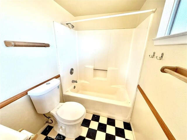 bathroom featuring shower / bath combination and toilet