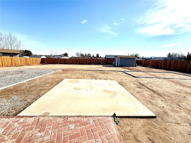 view of yard featuring a patio area and a shed