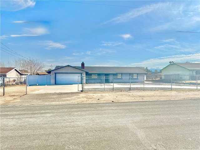 view of front of property with concrete driveway and a fenced front yard