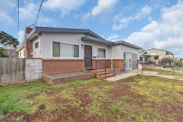 bungalow-style home featuring a front yard