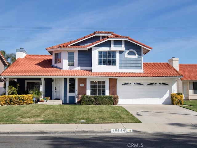 view of front of home featuring a front yard and a garage