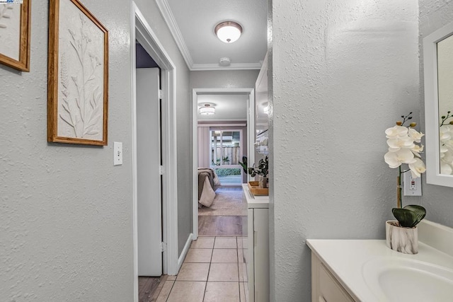 bathroom featuring tile patterned floors, ornamental molding, and vanity