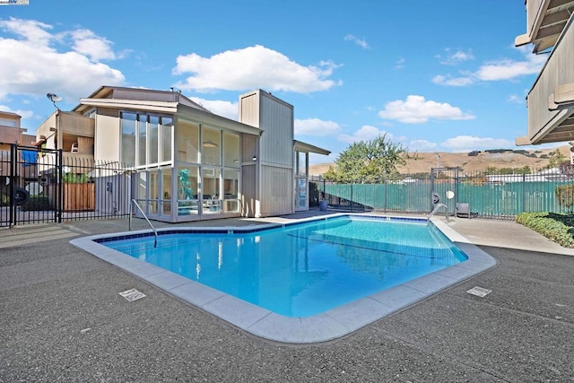 view of pool with a mountain view and a patio