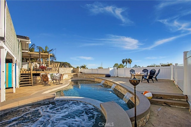 view of swimming pool with an in ground hot tub, pool water feature, and a patio area