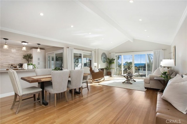 dining area featuring lofted ceiling with beams and light hardwood / wood-style floors