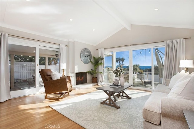 living room featuring crown molding, lofted ceiling with beams, and light hardwood / wood-style floors