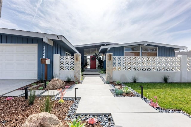 view of front of property featuring a garage and a front lawn