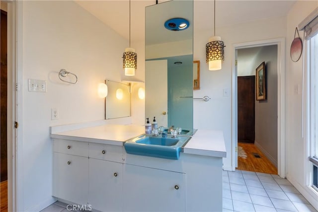 bathroom with tile patterned floors and vanity