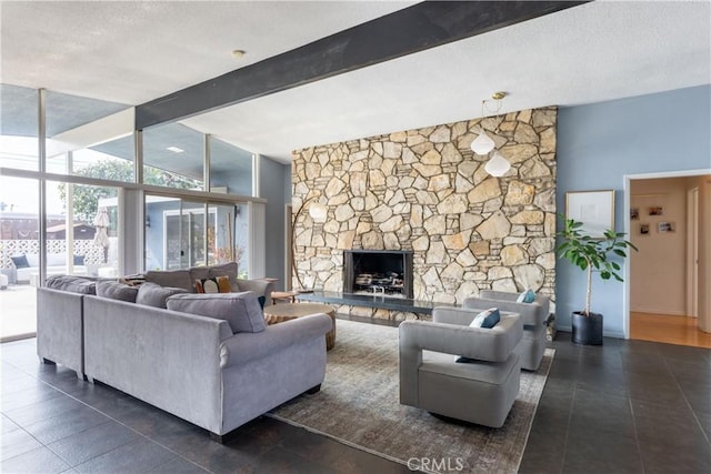 tiled living room featuring a stone fireplace, a textured ceiling, and vaulted ceiling with beams