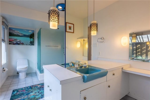 bathroom featuring walk in shower, vanity, toilet, and tile patterned flooring